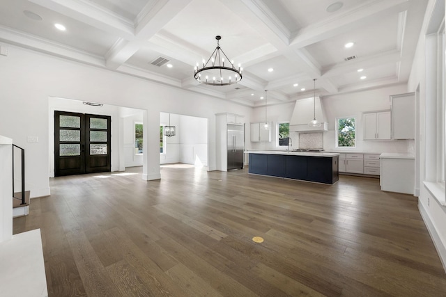 3714 Grennoch Ln, Houston, TX 77025 - unfurnished living room featuring a chandelier, coffered ceiling, dark wood-type flooring, beam ceiling, and a high ceiling