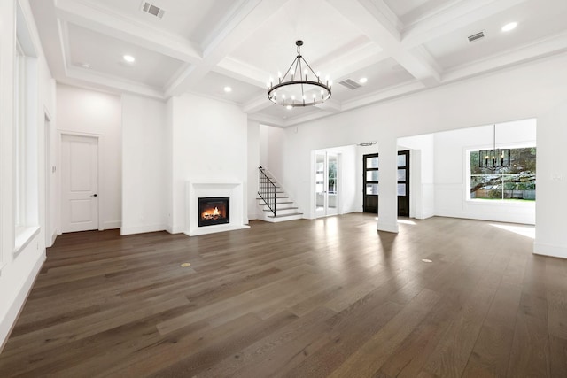 3714 Grennoch Ln, Houston, TX 77025 - unfurnished living room featuring a chandelier, plenty of natural light, a glass covered fireplace, coffered ceiling, and dark wood finished floors
