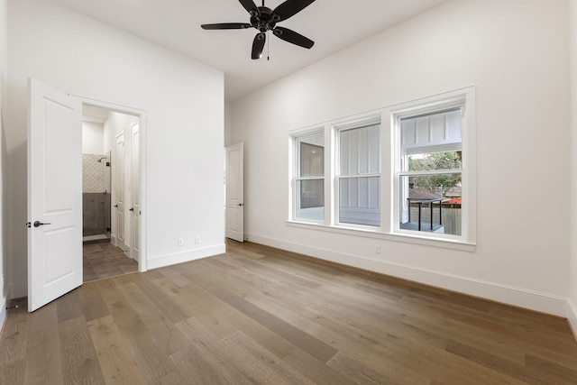 3714 Grennoch Ln, Houston, TX 77025 - unfurnished bedroom with wood finished floors, baseboards, ensuite bath, and ceiling fan