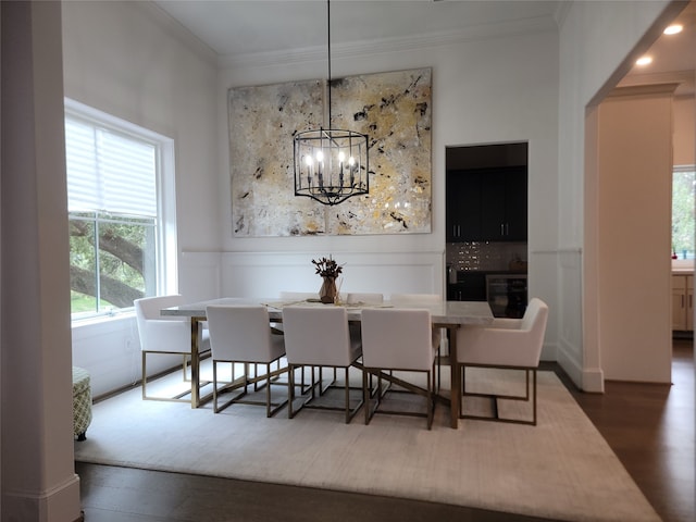 3714 Grennoch Ln, Houston, TX 77025 - dining area featuring crown molding, a chandelier, dark wood-style floors, and wainscoting