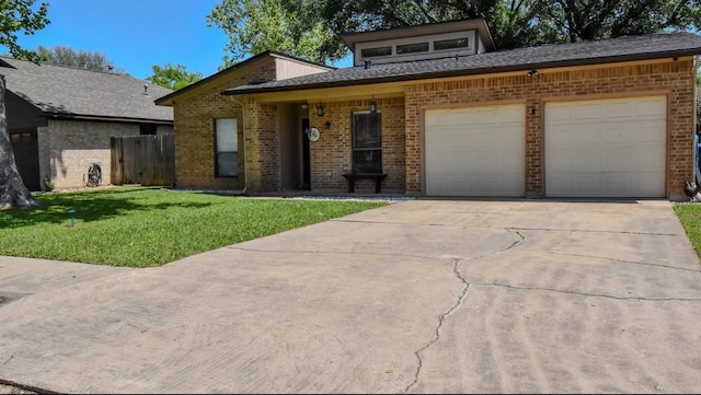 15 Murex St, Bay City, TX 77414 - view of front of home featuring brick siding, a garage, and concrete driveway