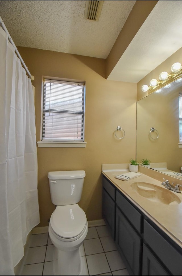 15 Murex St, Bay City, TX 77414 - bathroom with tile patterned floors, a textured ceiling, vanity, toilet, and baseboards