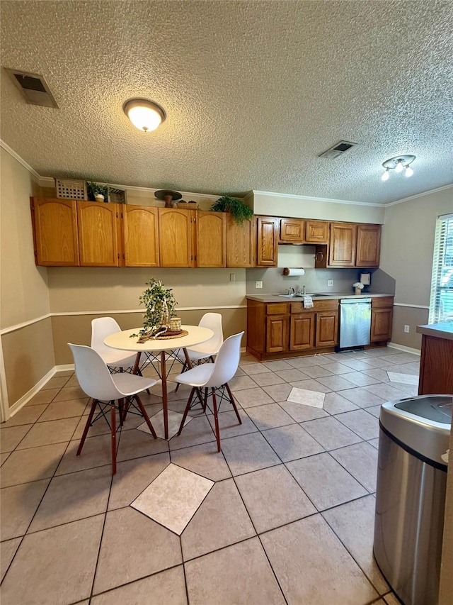 15 Murex St, Bay City, TX 77414 - kitchen with stainless steel dishwasher, crown molding, brown cabinets, a textured ceiling, and light tile patterned flooring