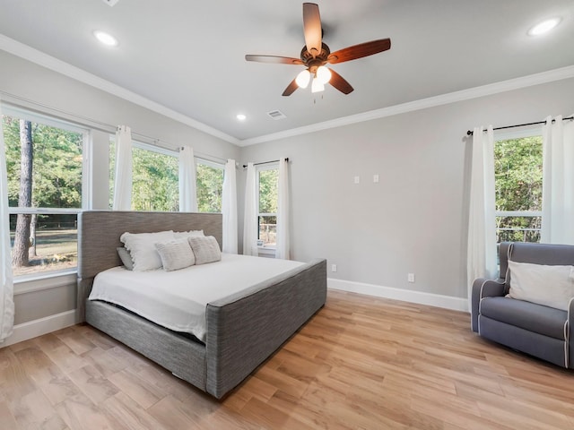 bedroom with baseboards and multiple windows