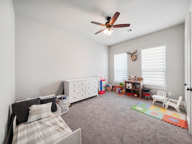 bedroom with carpet floors, visible vents, and ceiling fan