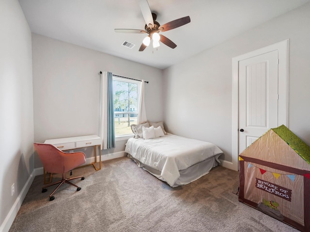 carpeted bedroom with visible vents, a ceiling fan, and baseboards
