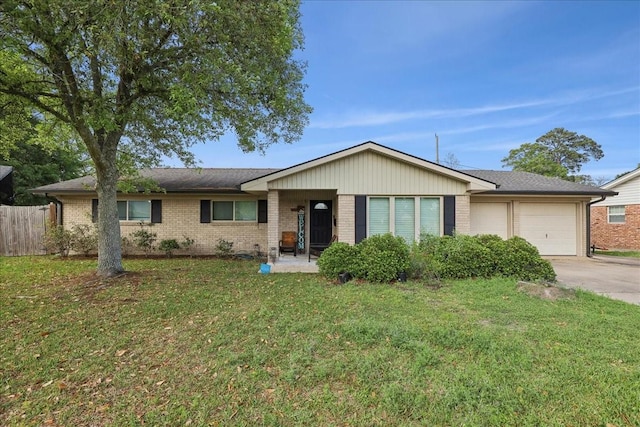 6360 Pansy Dr, Beaumont, TX 77706 - ranch-style home with fence, a front lawn, brick siding, a garage, and concrete driveway