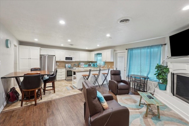 6360 Pansy Dr, Beaumont, TX 77706 - living area with recessed lighting, light wood-style floors, and visible vents