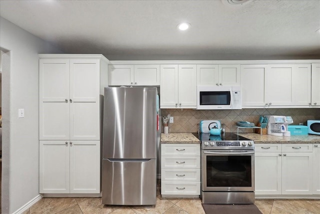 6360 Pansy Dr, Beaumont, TX 77706 - kitchen with light stone countertops, tasteful backsplash, appliances with stainless steel finishes, and white cabinets
