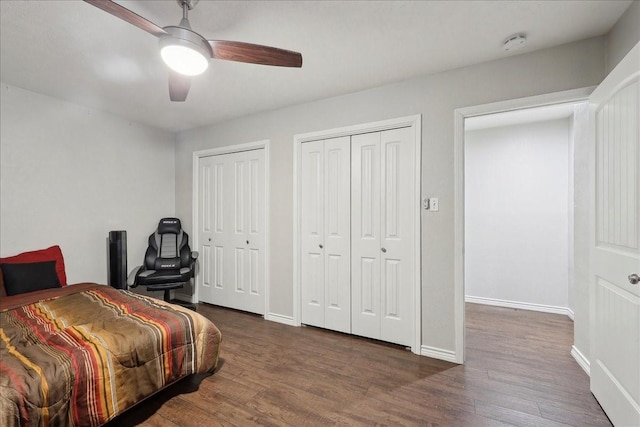 6360 Pansy Dr, Beaumont, TX 77706 - bedroom featuring dark wood-style floors, baseboards, and two closets