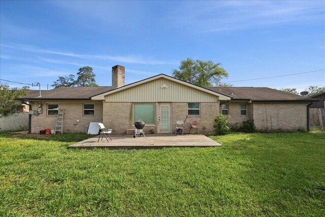 6360 Pansy Dr, Beaumont, TX 77706 - rear view of property featuring brick siding, a lawn, and a chimney