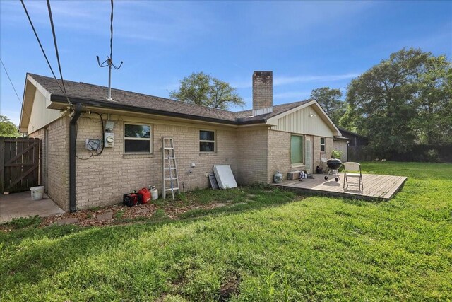 6360 Pansy Dr, Beaumont, TX 77706 - back of property with a yard, fence, brick siding, and a chimney