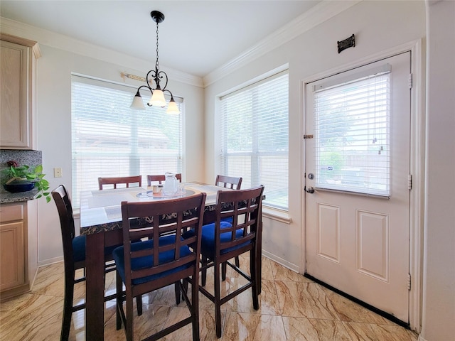 dining space with a notable chandelier, marble finish floor, baseboards, and ornamental molding