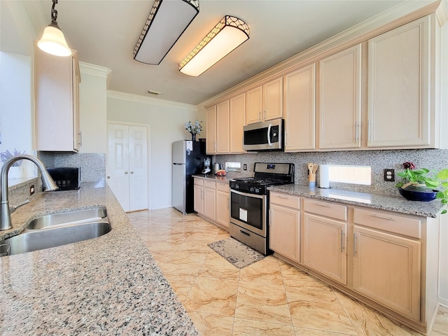 kitchen featuring ornamental molding, a sink, appliances with stainless steel finishes, and tasteful backsplash