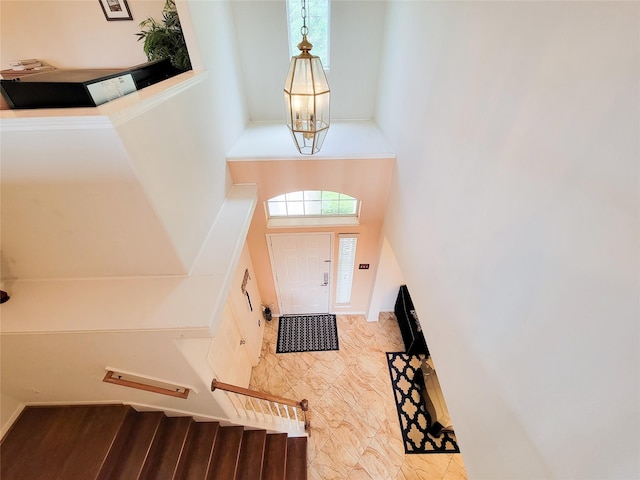 foyer entrance featuring a high ceiling and stairs