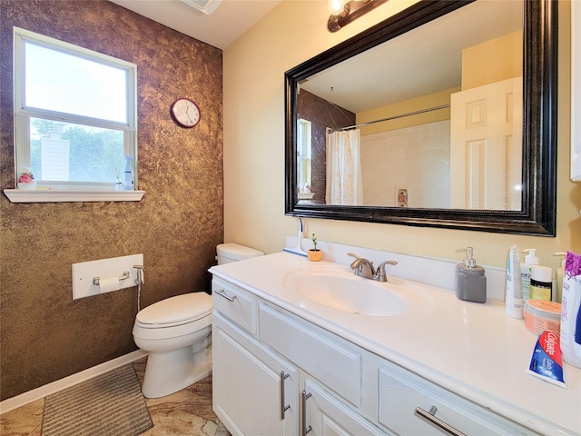 bathroom featuring vanity, curtained shower, and toilet
