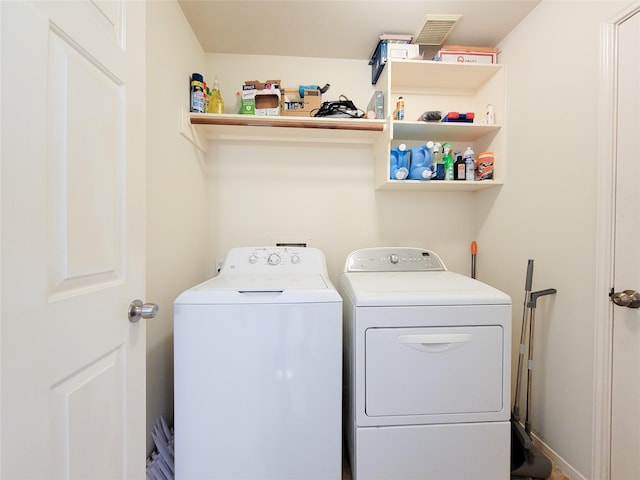 laundry room with washing machine and clothes dryer and laundry area