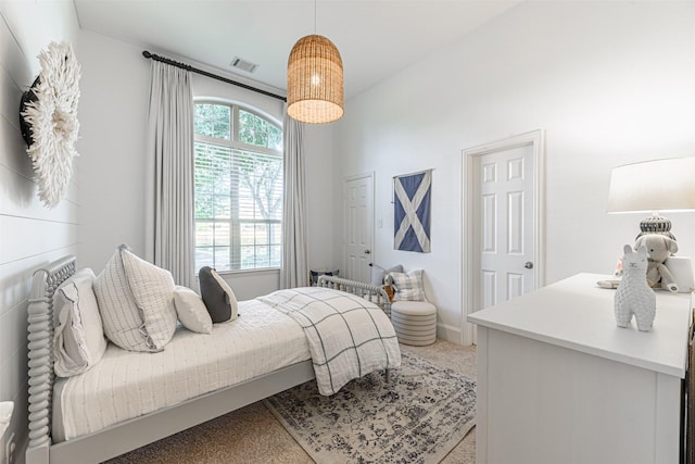 bedroom featuring light colored carpet, baseboards, and visible vents