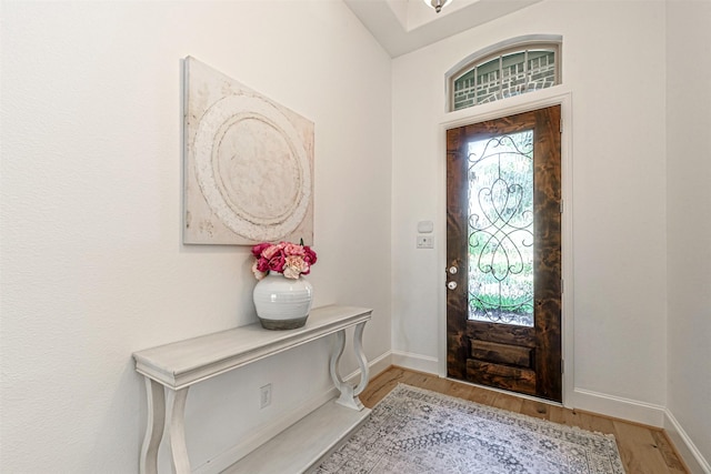 entryway with baseboards and light wood-type flooring