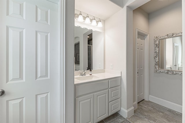 full bath featuring baseboards and vanity