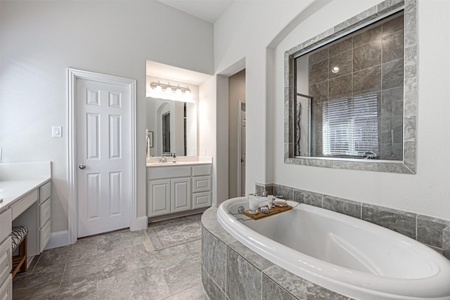 bathroom with a garden tub and vanity