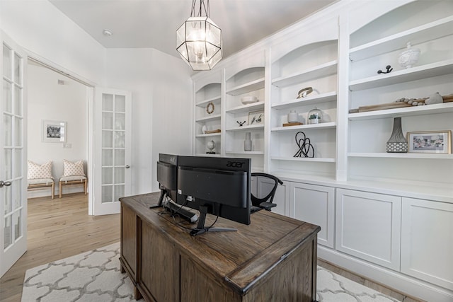 office space with french doors, a chandelier, and light wood-type flooring