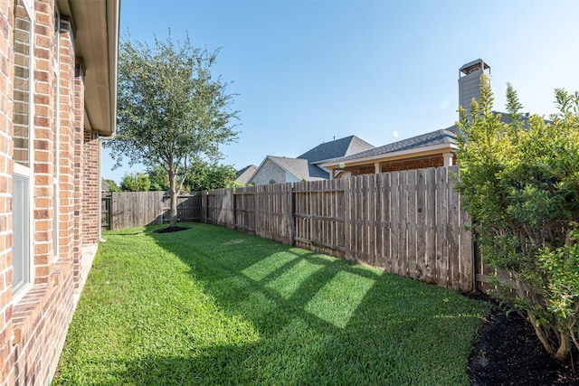 view of yard with a fenced backyard