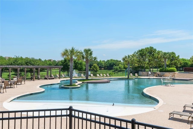pool with fence and a patio