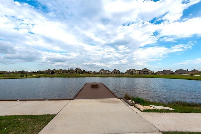 dock area with a residential view and a water view