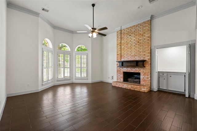 unfurnished living room featuring ornamental molding, ceiling fan, visible vents, and a fireplace