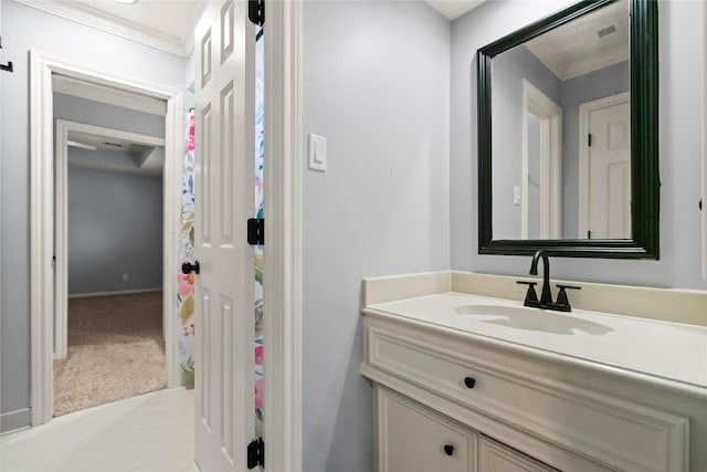 bathroom with vanity, baseboards, and crown molding