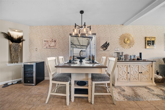 dining area with wine cooler, baseboards, a chandelier, and wallpapered walls