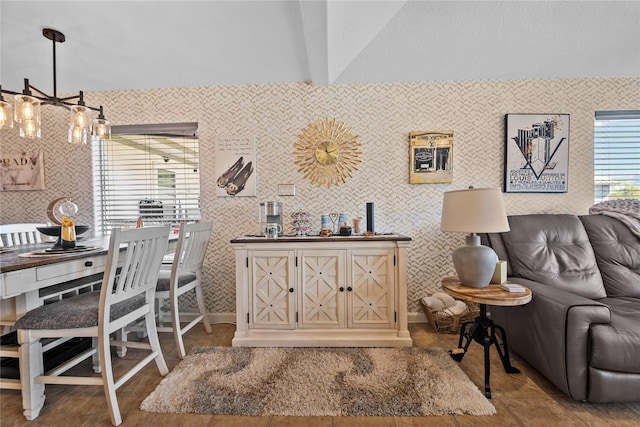 interior space featuring lofted ceiling and a notable chandelier