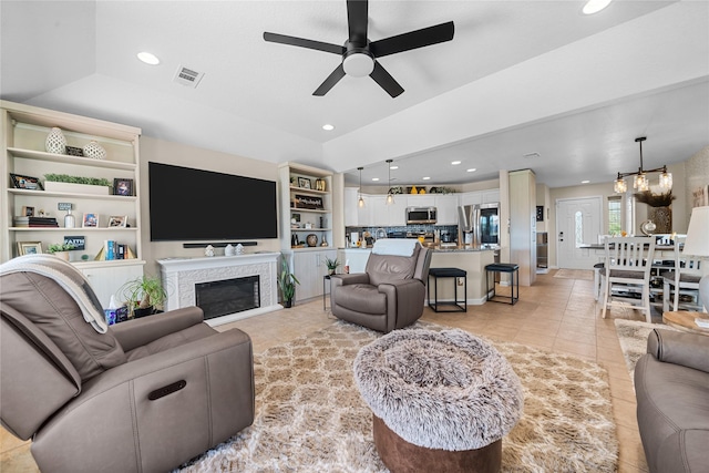 living area with visible vents, a ceiling fan, recessed lighting, and light tile patterned floors