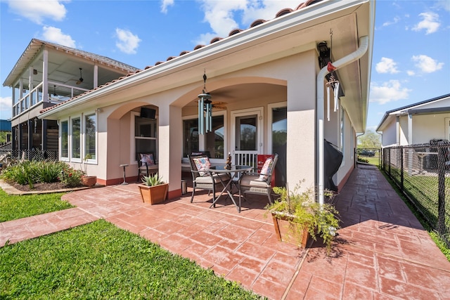 back of house featuring fence, a patio, and stucco siding