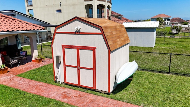 view of shed featuring fence