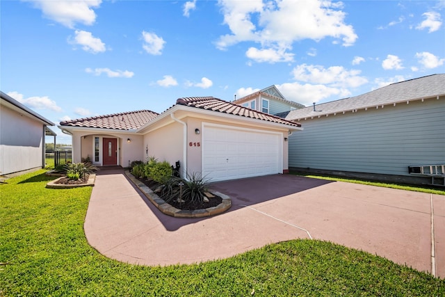 mediterranean / spanish house featuring a tiled roof, a front lawn, concrete driveway, stucco siding, and a garage