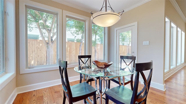 4404 Wendell St, Bellaire, TX 77401 - dining space featuring plenty of natural light, ornamental molding, light wood finished floors, and baseboards