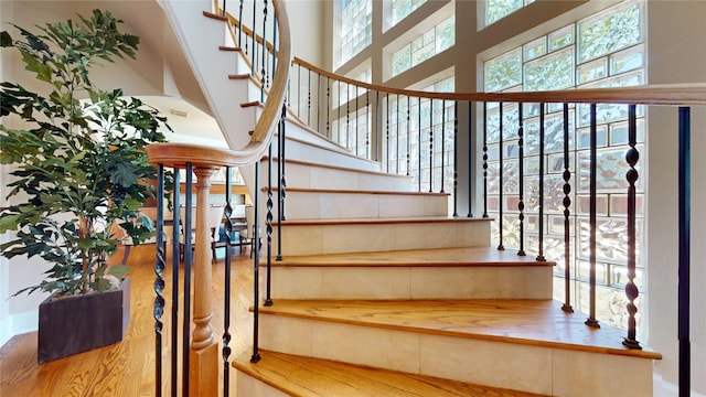 4404 Wendell St, Bellaire, TX 77401 - stairs with wood finished floors and a high ceiling