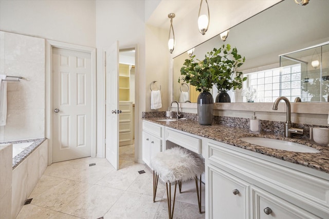 4404 Wendell St, Bellaire, TX 77401 - full bath featuring a stall shower, double vanity, a spacious closet, a tub to relax in, and tile patterned floors