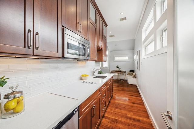 4404 Wendell St, Bellaire, TX 77401 - kitchen with stainless steel microwave, a sink, light countertops, and backsplash