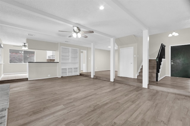 3142 La Quinta Dr, Missouri City, TX 77459 - unfurnished living room with stairway, wood finished floors, baseboards, a textured ceiling, and ceiling fan