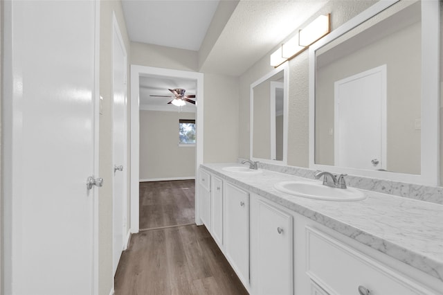 3142 La Quinta Dr, Missouri City, TX 77459 - bathroom with double vanity, wood finished floors, a ceiling fan, and a sink