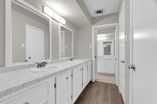 3142 La Quinta Dr, Missouri City, TX 77459 - full bath with wood finished floors, a sink, visible vents, and double vanity