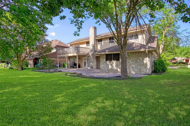 3142 La Quinta Dr, Missouri City, TX 77459 - back of house featuring a chimney, a balcony, a patio area, a lawn, and brick siding