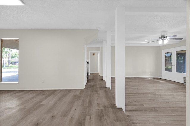 3142 La Quinta Dr, Missouri City, TX 77459 - unfurnished living room with baseboards, a ceiling fan, wood finished floors, and a textured ceiling
