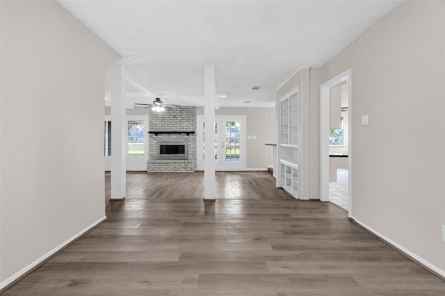 3142 La Quinta Dr, Missouri City, TX 77459 - unfurnished living room featuring ceiling fan, baseboards, wood finished floors, and a fireplace