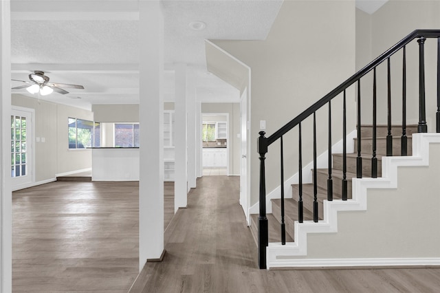 3142 La Quinta Dr, Missouri City, TX 77459 - foyer with stairway, baseboards, a ceiling fan, and wood finished floors