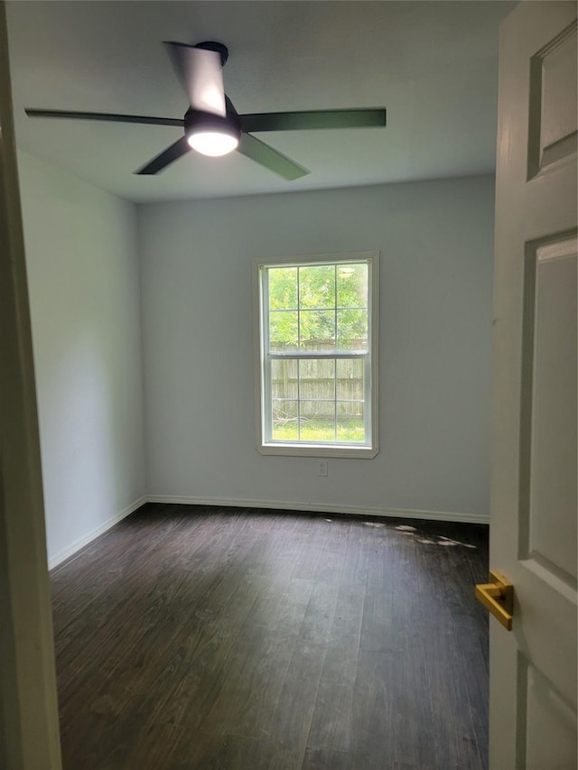 8424 Botany Ln, Houston, TX 77075 - empty room with dark wood-style flooring, baseboards, and ceiling fan