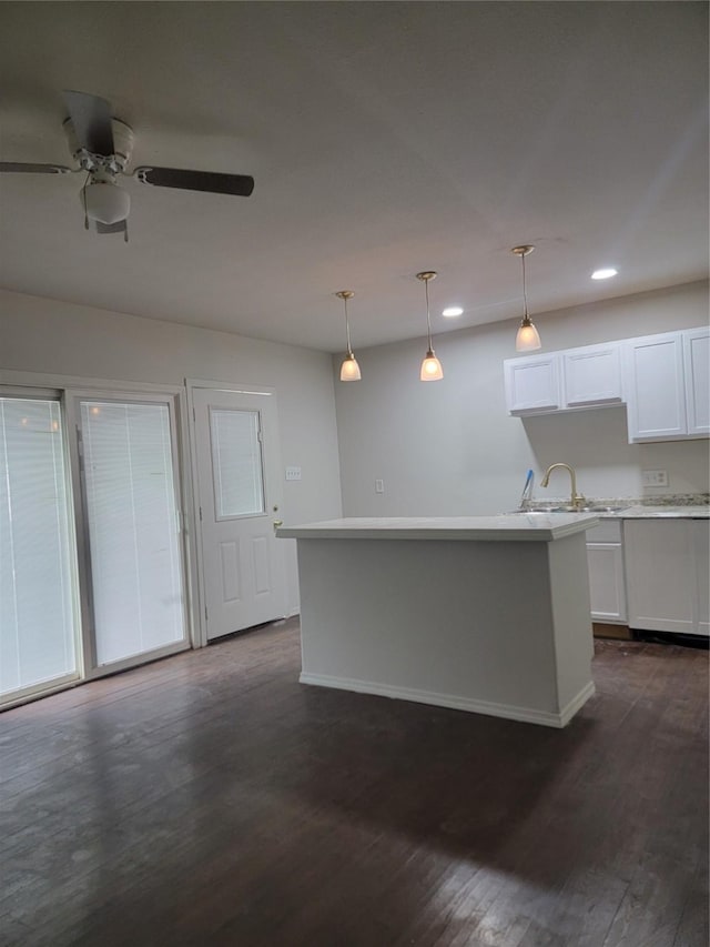 8424 Botany Ln, Houston, TX 77075 - kitchen featuring pendant lighting, ceiling fan, white cabinets, recessed lighting, and a sink